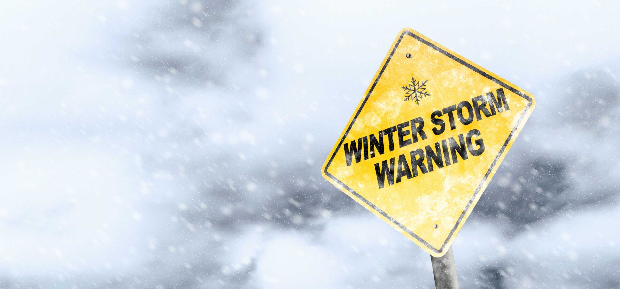 Winter Storm Warning Sign With Snowfall and Stormy Background