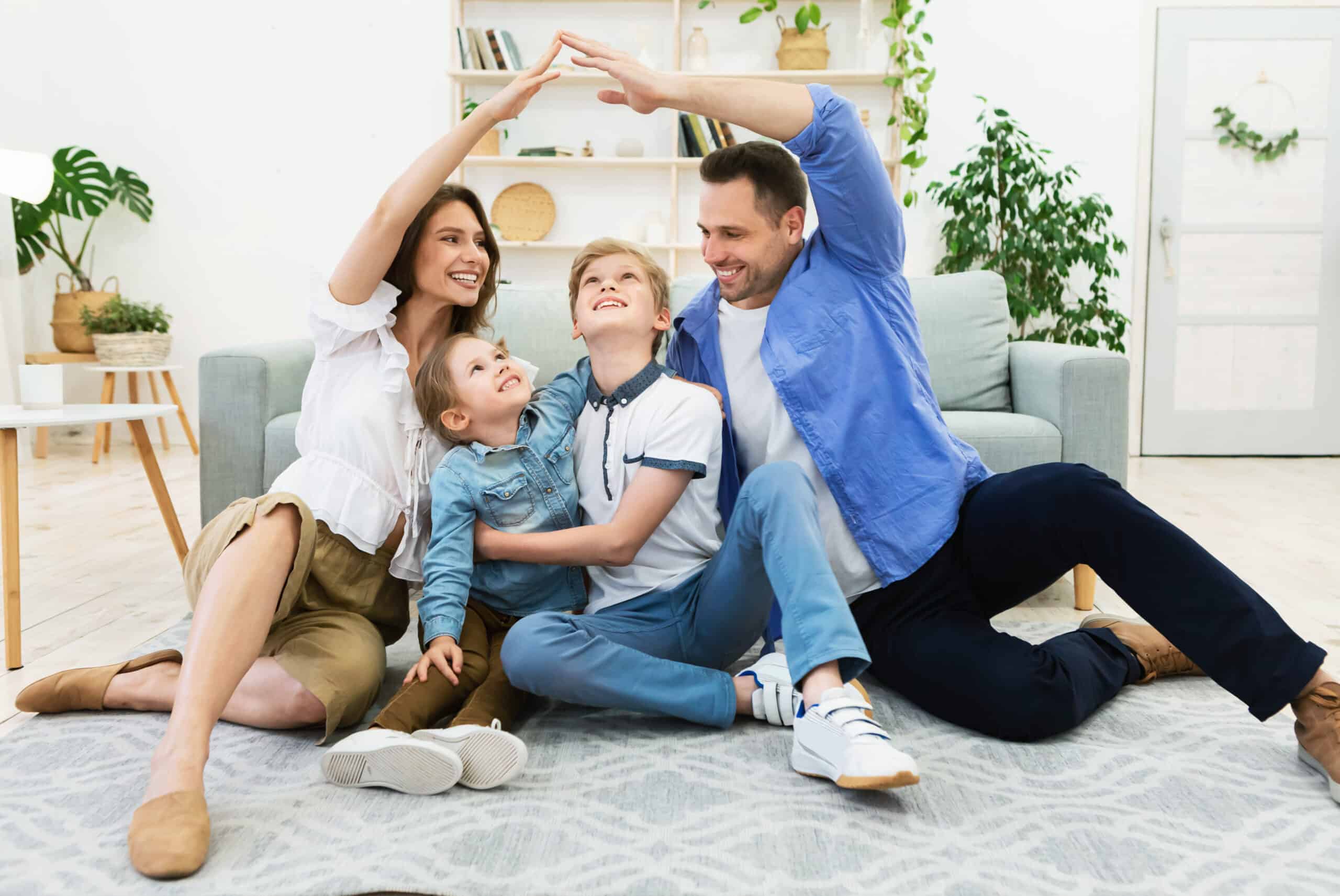 Family enjoying playful moment on living room floor, symbolizing home safety and protection with Tower Hill Insurance.